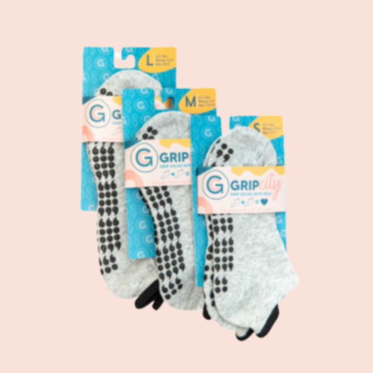 Semi colon mental health grip socks in small medium and large. gray sock with black sticky grippy treads. Hang tag built in